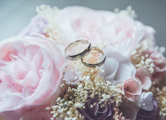 flowers and wedding bands to show the commitment between two people on a wedding day. Weddings can be very stress-inducing. Seek out a couples therapist to help with anxiety and stress during wedding planning.