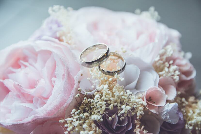 flowers and wedding bands to show the commitment between two people on a wedding day. Weddings can be very stress-inducing. Seek out a couples therapist to help with anxiety and stress during wedding planning.