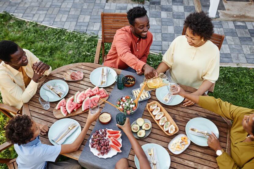 A family toast while talking around a dinner table. Learn how counseling in Branchburg, NJ can offer support with therapy Branchburg, NJ. Search for online group therapy in New Jersey today.