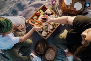 two people enjoying a picnic together, bridging the gap between their everyday passions and equestrian riding. If you want a therapist who understands equestrian anxiety in NJ, contact us today.