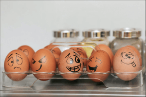 Tray of eggs with different emotions, showing what it could be like to experience a whirlwind of emotions while dealing with infertility treatments. A grief therapist in Scotch Plains or Branchburg, NJ can help you process complicated feelings while or after going through infertility. 