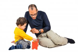 A father and son play with a wooden toy. This could symbolize the power of play in addressing childhood anxiety. Contact a child therapist in Branchburg, NJ to learn more about child therapy for anxiety and the support that child therapy in Scotch Plains, NJ can offer. 