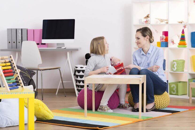 A woman smiles at a child during a play therapy session. This could represent the support child therapy in New Jersey can offer in addressing child anxiety. Learn more about the hlep a child therapist in Branchburg, NJ can offer by searching for child counseling in Branchburg, NJ today.