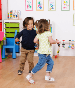 Two children dancing and moving in a safe place. Dance and somatic movement can be a coping mechanism for children with anxiety. Find a child therapist near you to help identify creating coping mechanisms for child anxiety.