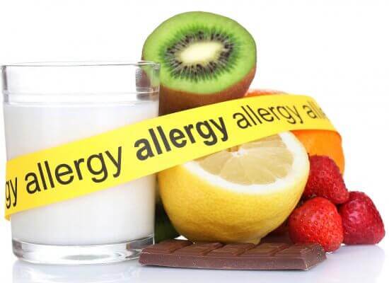 A close up of tape with the word "allergy" surrounding different foods including milk, lemons, and strawberries. Get support for food allergies and anxiety by seaching for an anxiety therapist in Branchburg, NJ. Learn more about teens with food allergies New Jersey today.