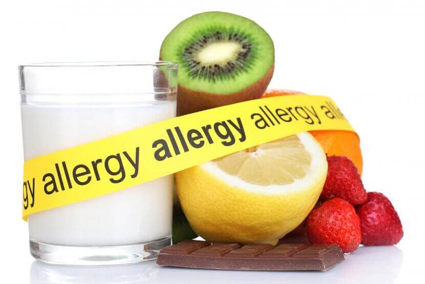 A close up of tape with the word "allergy" surrounding different foods including milk, lemons, and strawberries. Get support for food allergies and anxiety by seaching for an anxiety therapist in Branchburg, NJ. Learn more about teens with food allergies New Jersey today.