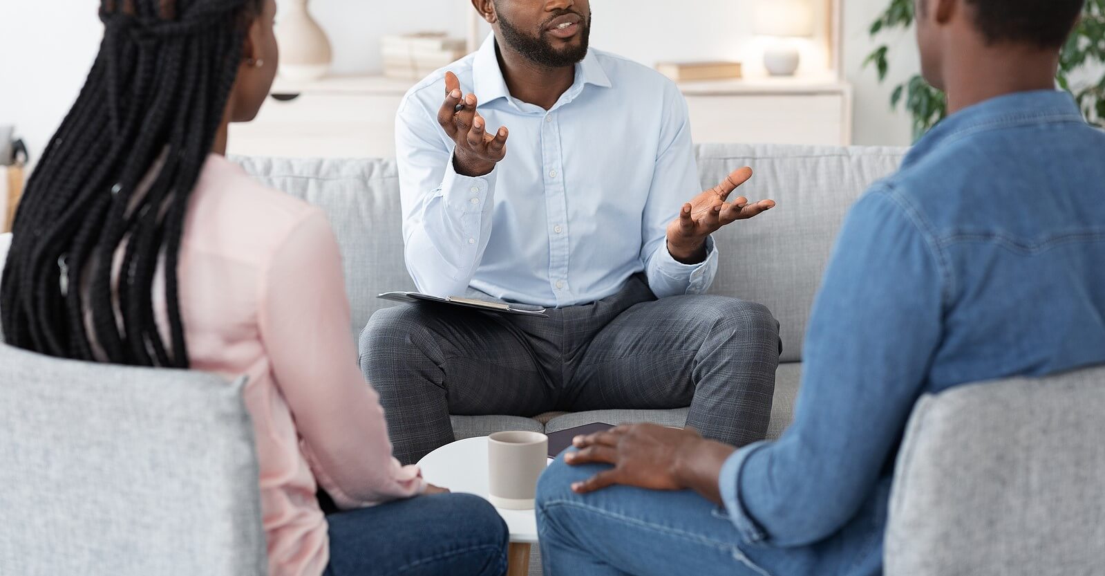A person talks to a man and woman sitting across from them while gesticulating with their hands. learn how a family theapist in Branchburg, NJ can offer parenting help. Search for therapy branchburg, nj to get in contact with a group therapist in Scotch Plains, NJ today.