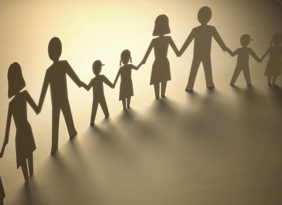Silhouette of a line of diverse figures holding hands, casting long shadows on a golden background. Family therapy can help identify the needs and goals for families. Look for a family therapist in Scotch Plains or Branchburg today!