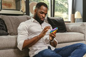 Neurodivergent adult using a sensory tool at home, reflecting support available through a therapist for neurodivergent adults in New Jersey and resources for neurodivergence NJ.