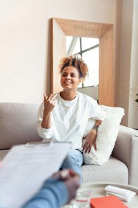 Young woman smiling during a therapy session, representing supportive neurodivergent therapy in New Jersey and access to inclusive neurodivergent resources NJ.