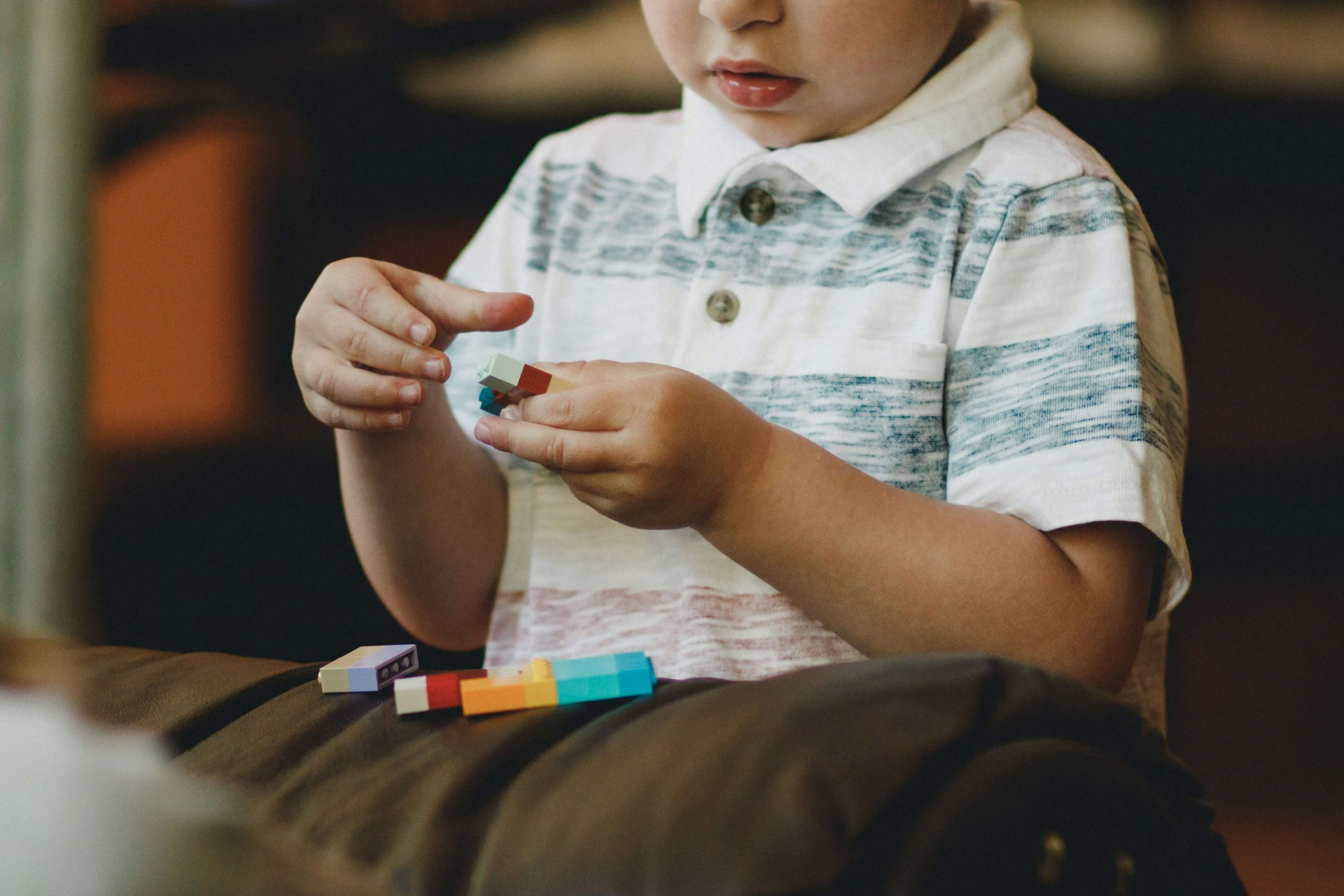 A young boy engaged with colorful building blocks during a child counseling session in Branchburg, NJ. Serving families in Scotch Plains, Somerville, and nearby NJ towns seeking support with explaining therapy to a child and child counseling in Branchburg, NJ.