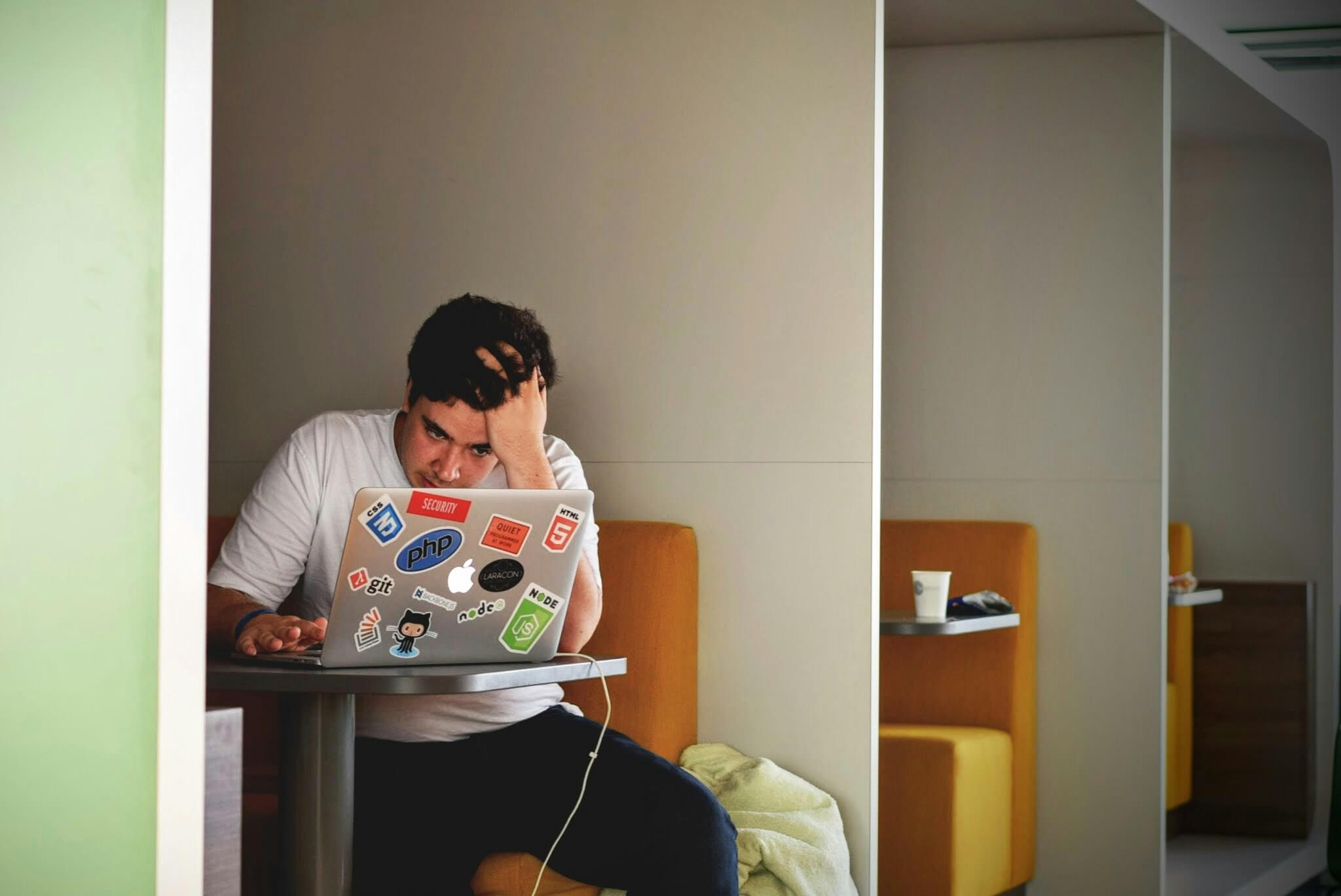 Person experiencing emotional overwhelm while viewing content online, representing the mental health impact of current events and social media in Somerville. Serving Somerville, Scotch Plains, and Branchburg, grief counseling is available for those struggling with collective grief and moral distress from news and social media.
