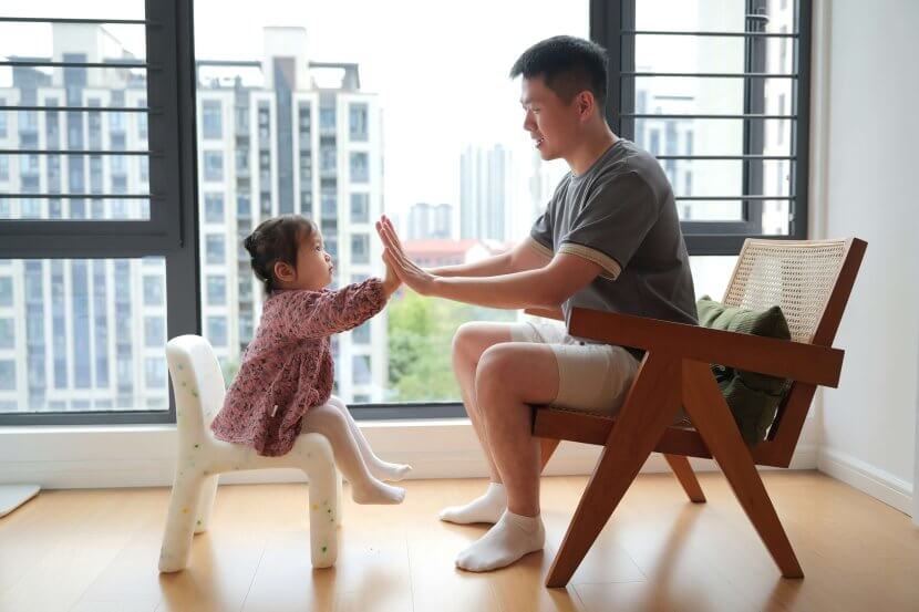 A father and young daughter share a validating high-five moment in Branchburg. Serving Branchburg, Somerville, and the surrounding NJ community with child therapy and parent coaching focused on emotional regulation skills.